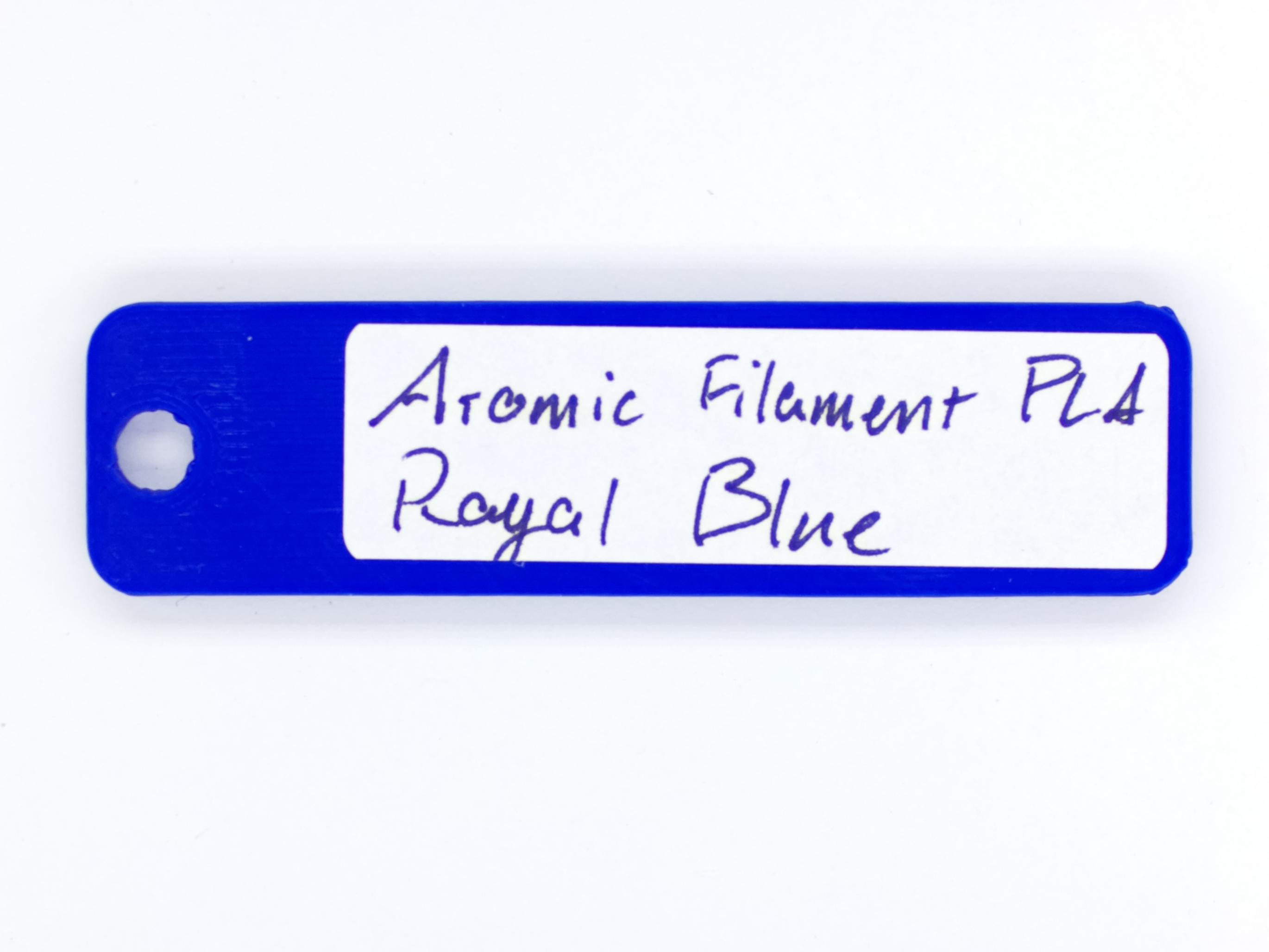 An image of the back of a color swatch, with the manufacturer, type, and color written on it.