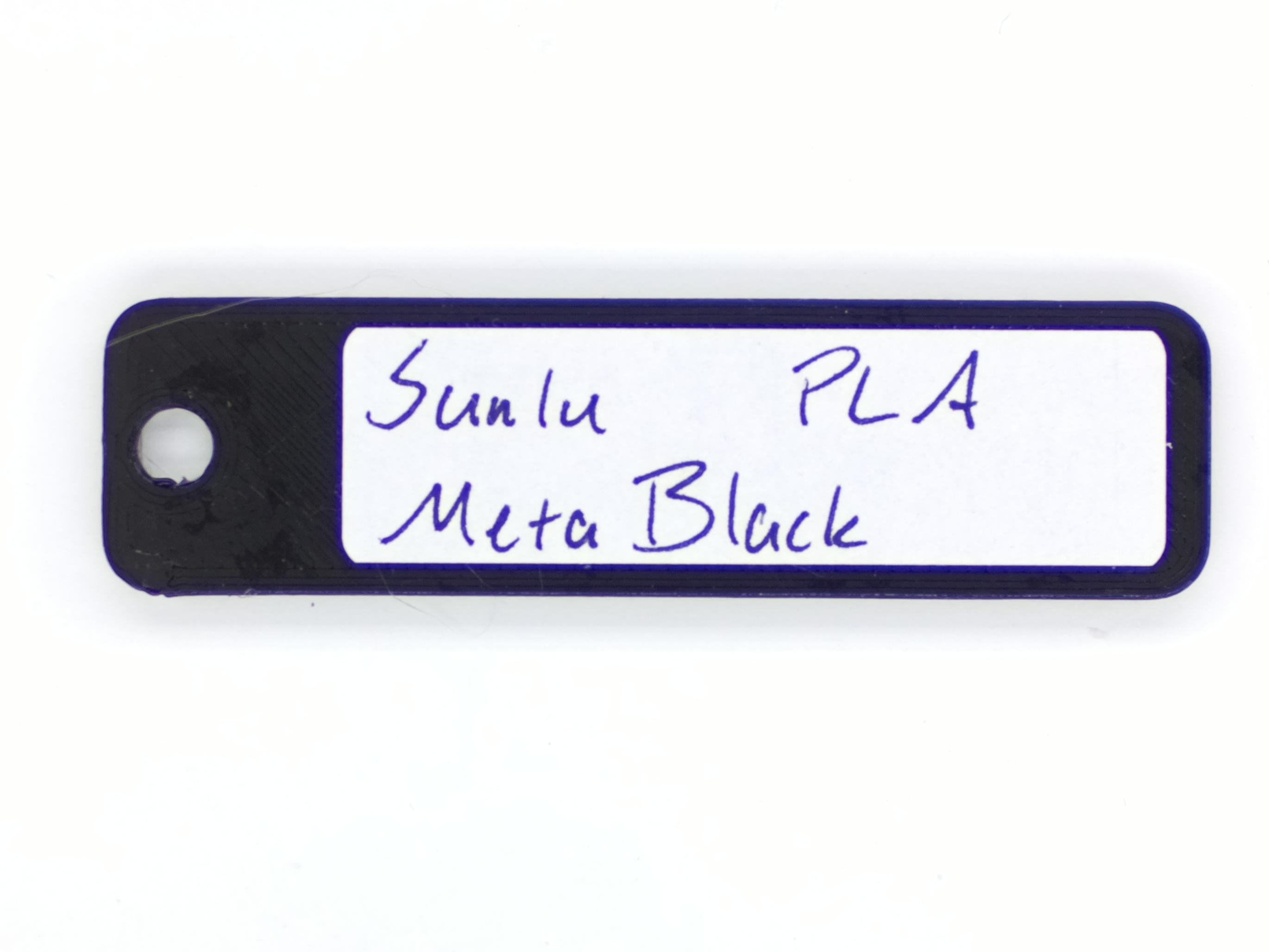 An image of the back of a color swatch, with the manufacturer, type, and color written on it.